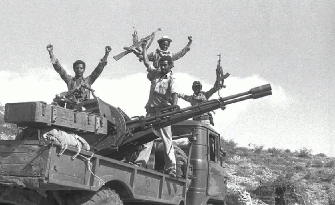 EPLF fighters standing on a truck after the Battle of Nakfa, fists raised